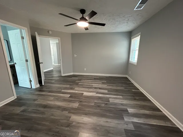 wooden floor in an empty room with a mirror