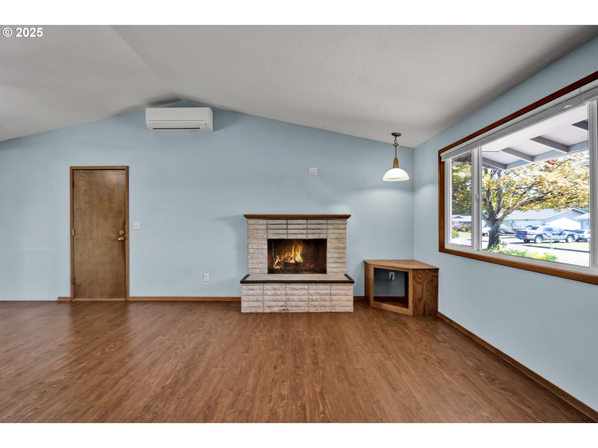 3760 Cherokee Drive Springfield, OR 97478 - Photo 13 of 42 a view of an empty room with wooden floor fireplace and a window