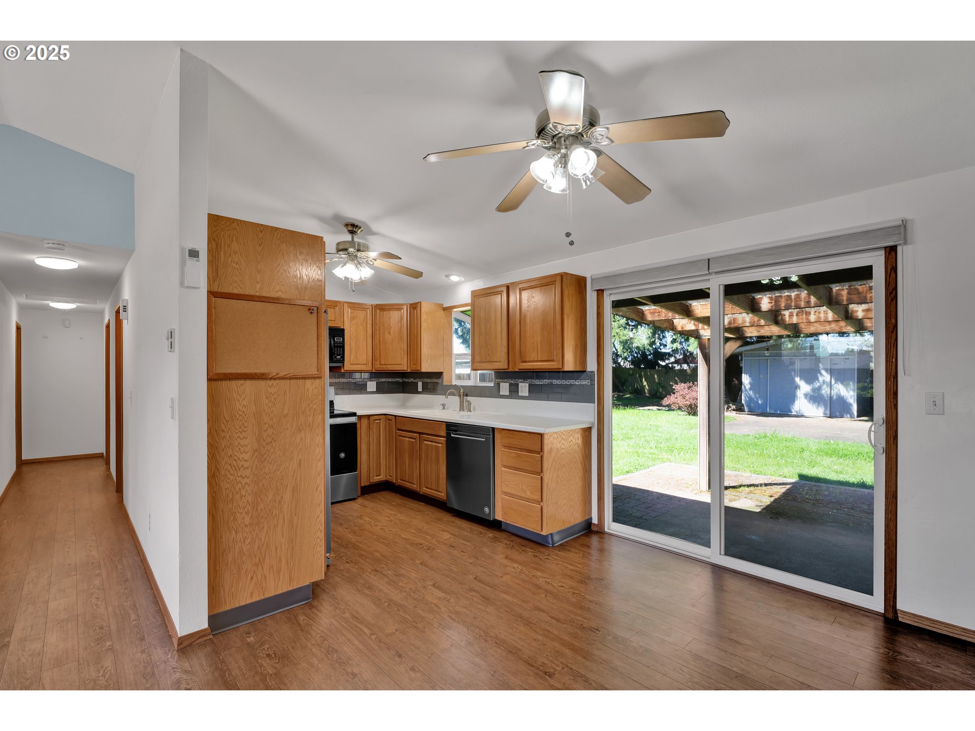 3760 Cherokee Drive Springfield, OR 97478 - Photo 14 of 42 a view of kitchen with refrigerator and wooden floor