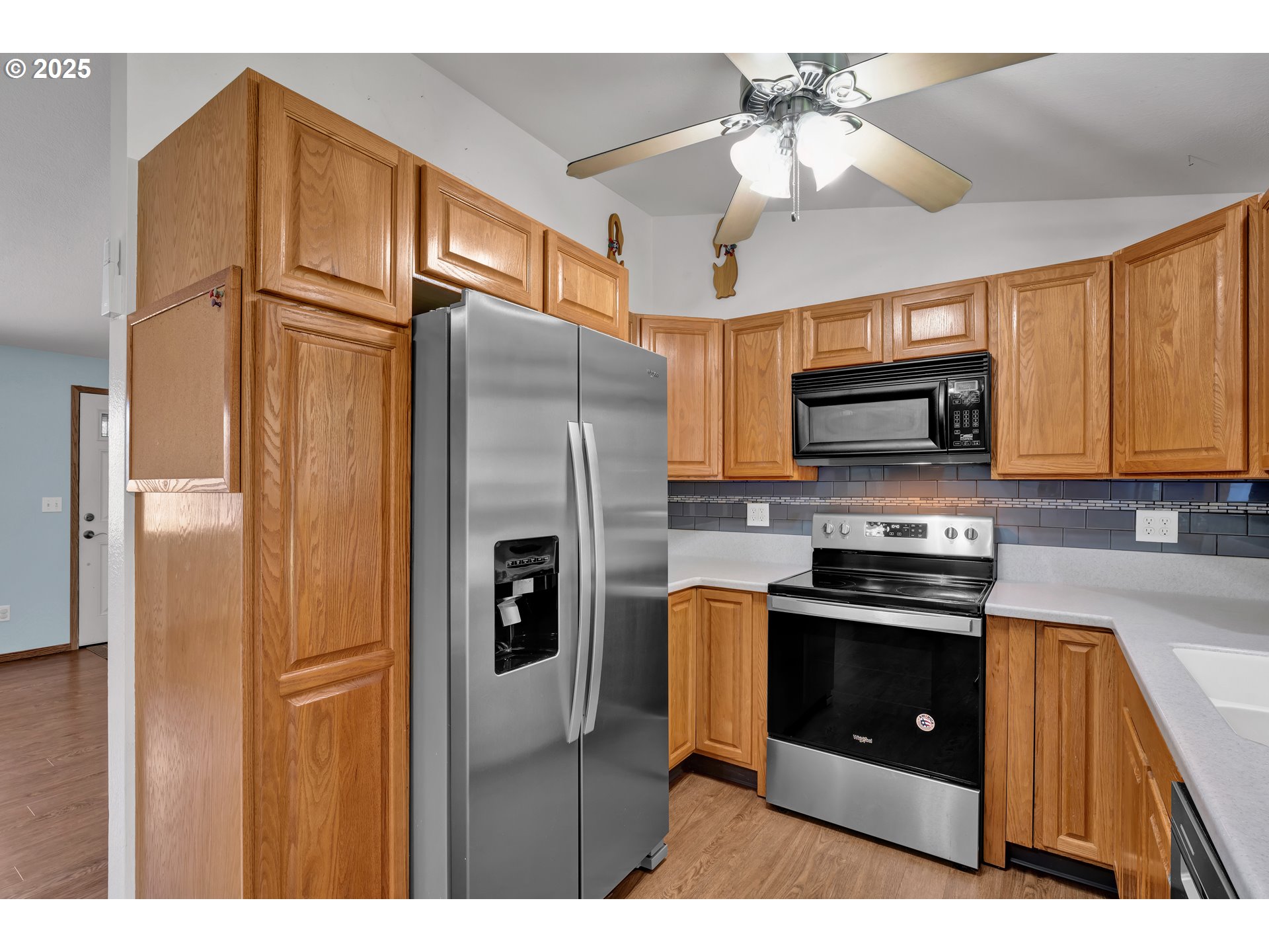 3760 Cherokee Drive Springfield, OR 97478 - Photo 16 of 42 a kitchen with stainless steel appliances granite countertop a refrigerator a stove top oven a sink and dishwasher