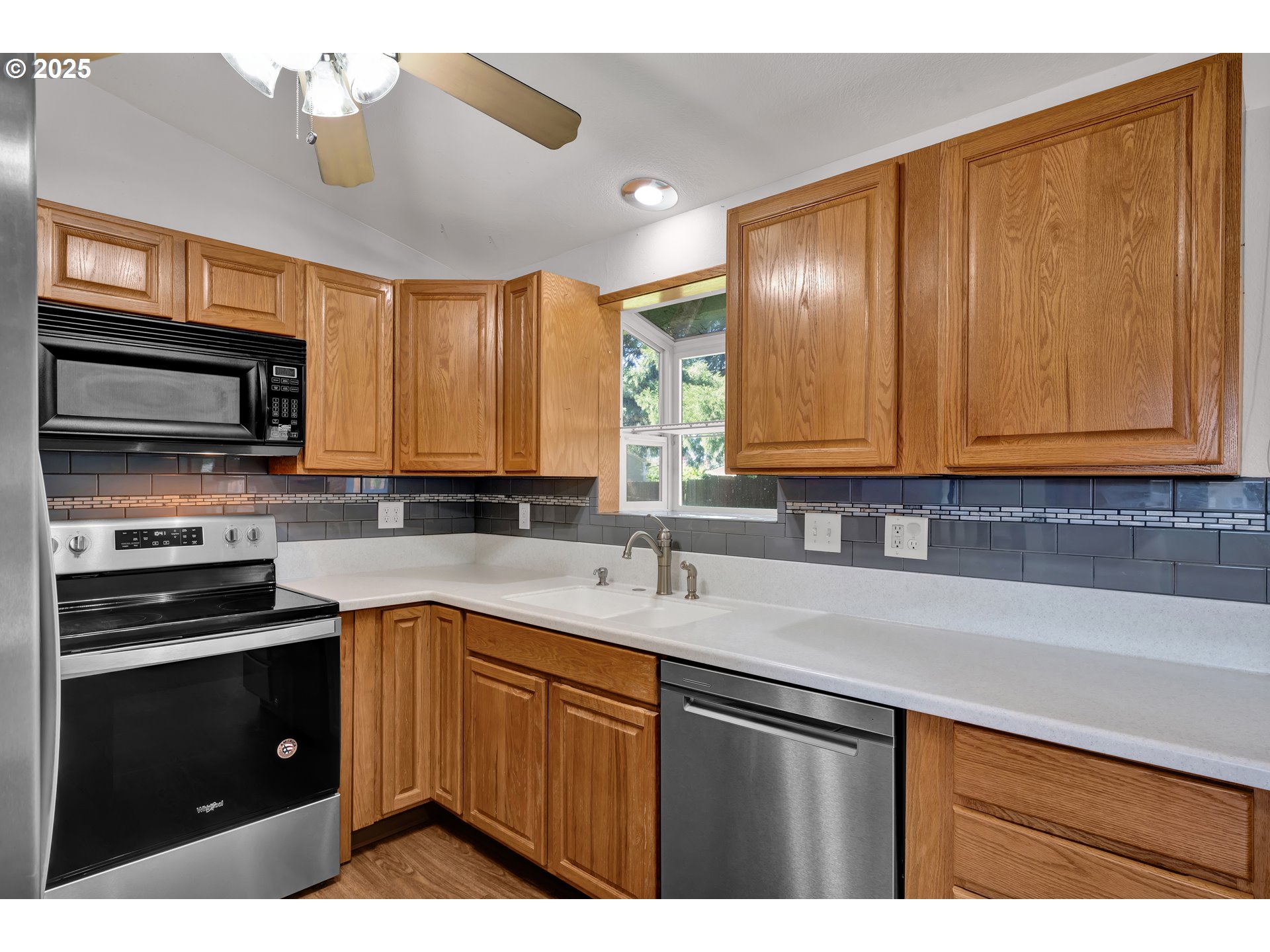 3760 Cherokee Drive Springfield, OR 97478 - Photo 17 of 42 a kitchen with stainless steel appliances granite countertop a sink stove and microwave