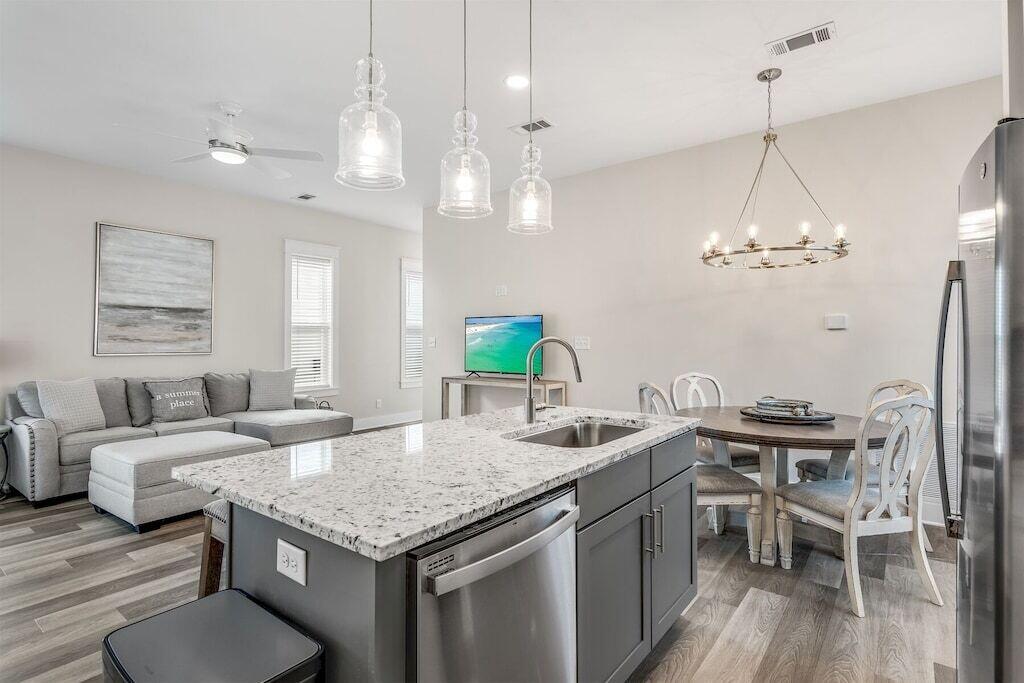 24 Beach View Dr Inlet Beach Inlet Beach, FL 32461 - Photo 2 of 27 a kitchen with a stove a counter space dining table and chairs