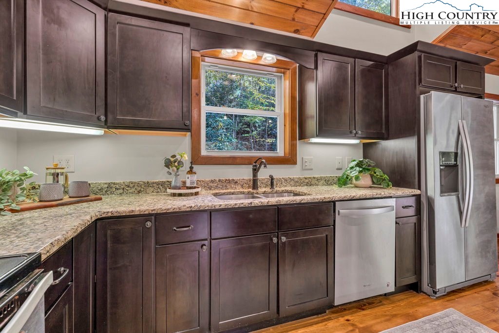 359 Sorrento Falls Road Blowing Rock, NC 28605 - Photo 15 of 46 a kitchen with stainless steel appliances granite countertop a sink stove and refrigerator