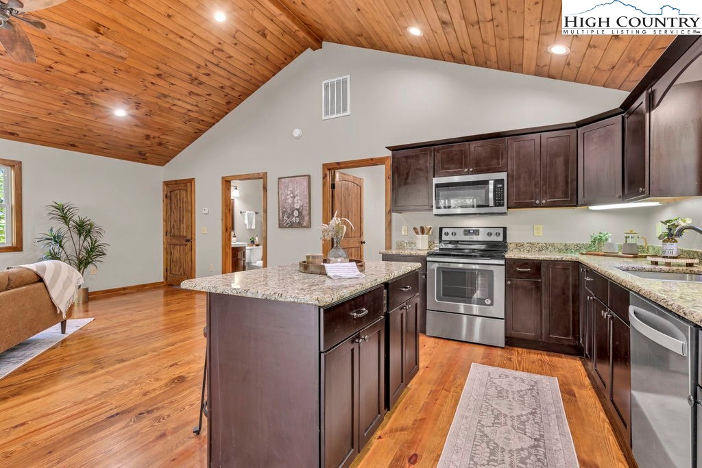 359 Sorrento Falls Road Blowing Rock, NC 28605 - Photo 16 of 46 a kitchen with stainless steel appliances granite countertop a sink stove and refrigerator