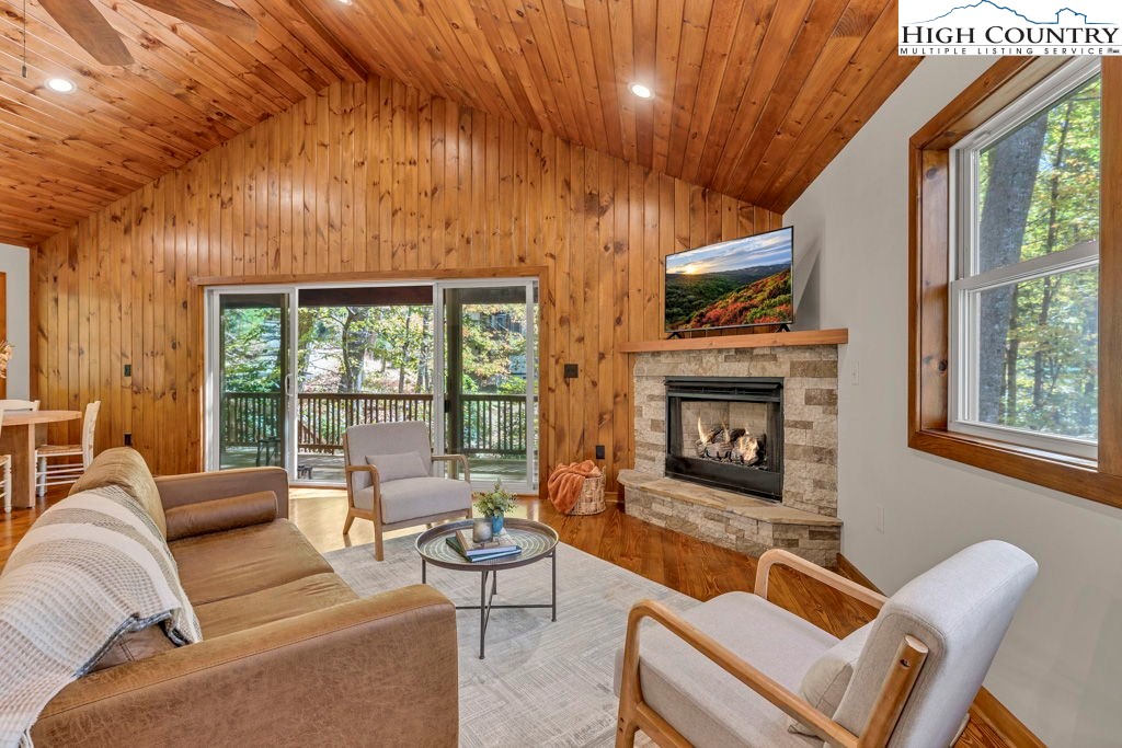 359 Sorrento Falls Road Blowing Rock, NC 28605 - Photo 20 of 46 a living room with furniture a fireplace and a floor to ceiling window