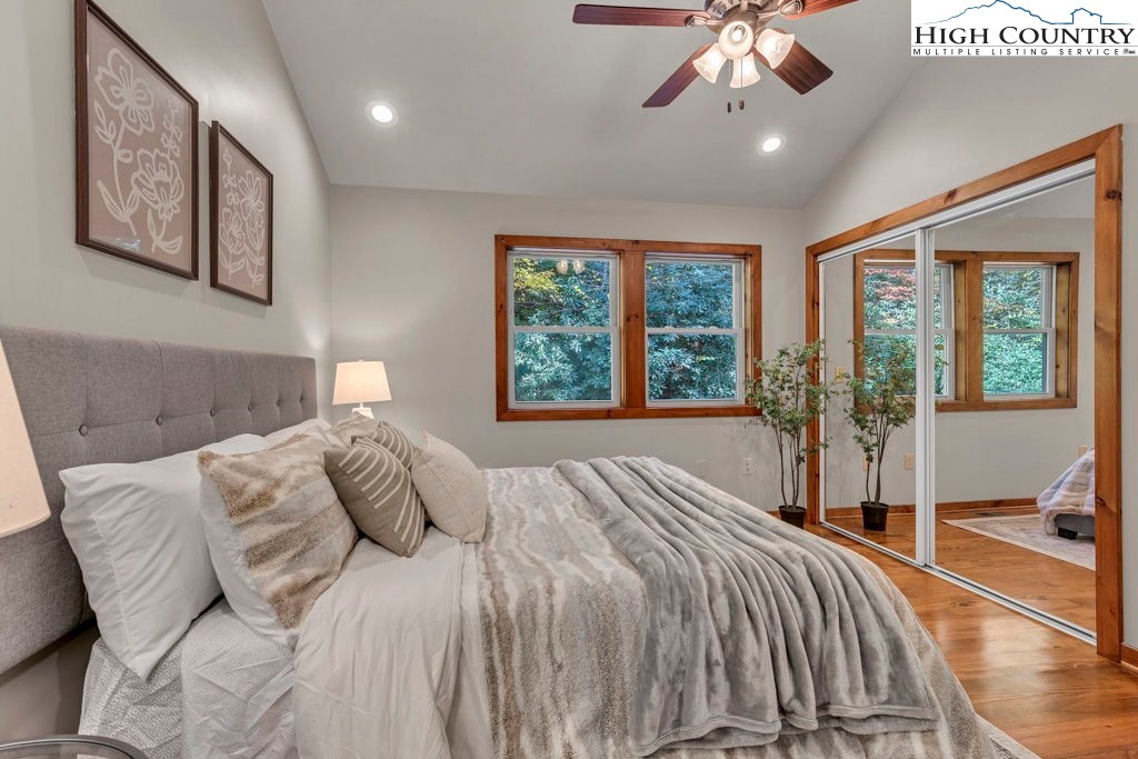 359 Sorrento Falls Road Blowing Rock, NC 28605 - Photo 22 of 46 a bedroom with a large bed and a large window