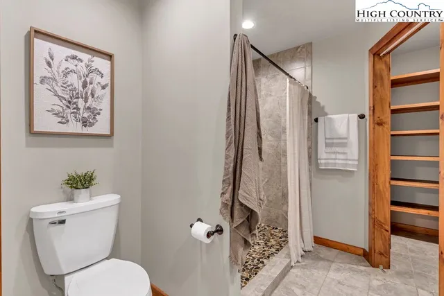 a bathroom with a toilet and a shower