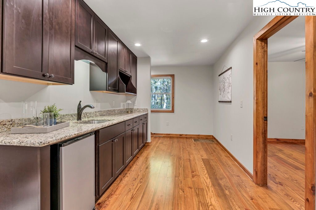 359 Sorrento Falls Road Blowing Rock, NC 28605 - Photo 31 of 46 a kitchen with granite countertop wooden cabinets a sink and dishwasher