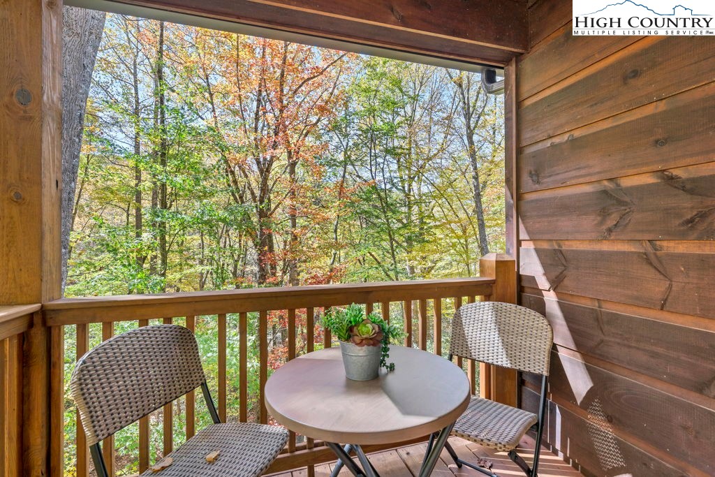 359 Sorrento Falls Road Blowing Rock, NC 28605 - Photo 4 of 46 a view of a city from a dining room with large windows