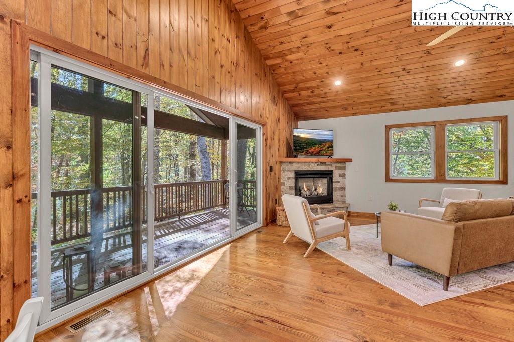 359 Sorrento Falls Road Blowing Rock, NC 28605 - Photo 6 of 46 a living room with furniture large windows and wooden floor