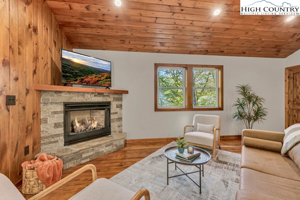 359 Sorrento Falls Road Blowing Rock, NC 28605 - Photo 7 of 46 a living room with furniture a window and a fireplace