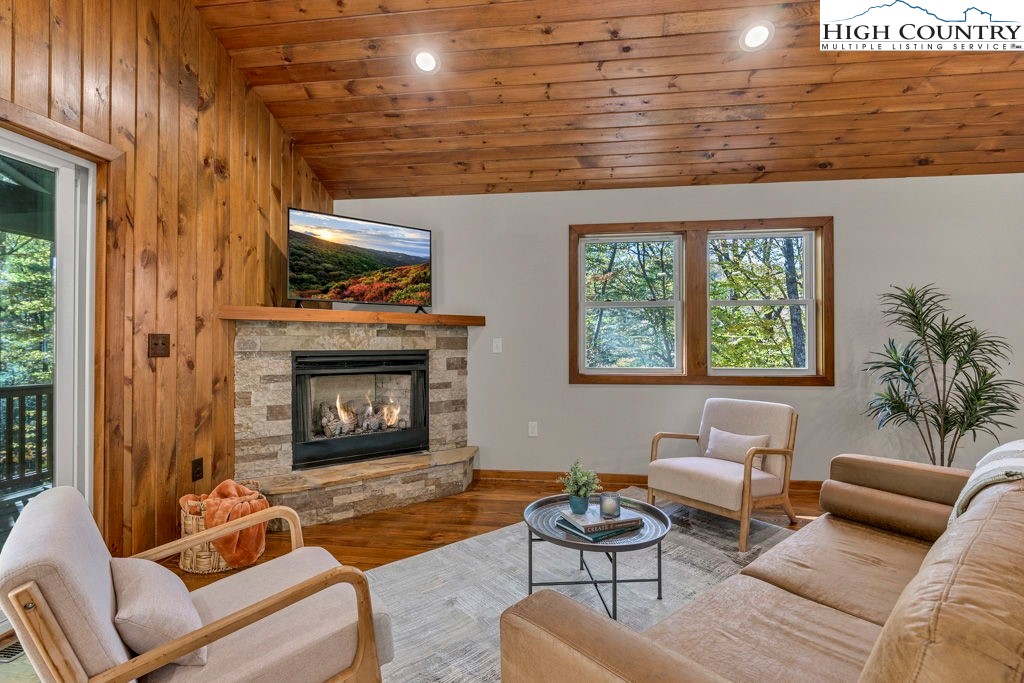 359 Sorrento Falls Road Blowing Rock, NC 28605 - Photo 8 of 46 a living room with furniture and a fireplace