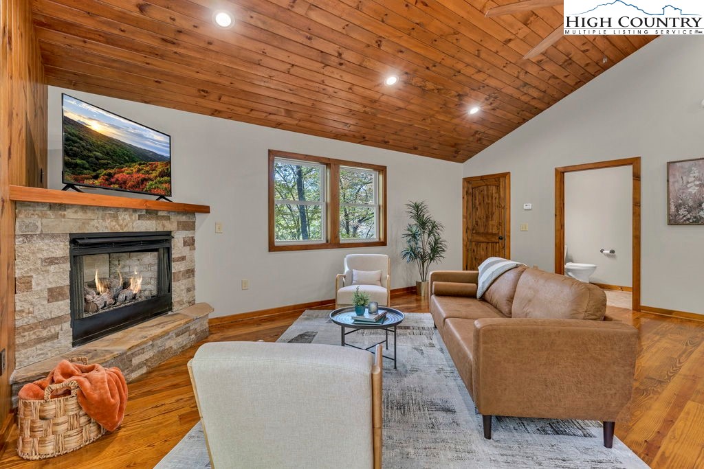 359 Sorrento Falls Road Blowing Rock, NC 28605 - Photo 9 of 46 a living room with furniture a flat screen tv and a fireplace
