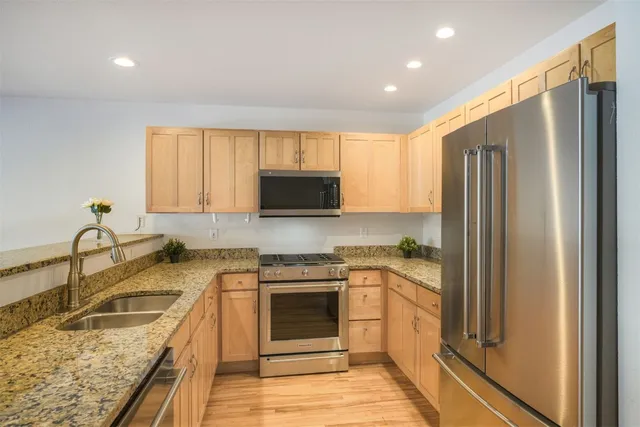 a kitchen with a sink stove and refrigerator