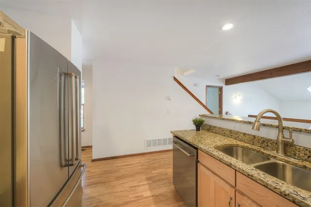 a kitchen with a sink and a refrigerator