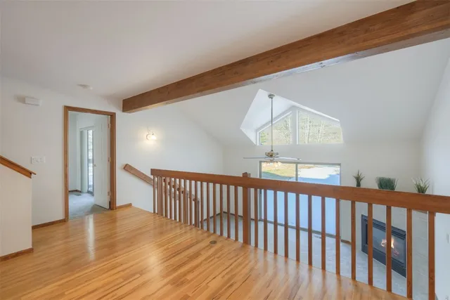 a view of hallway with wooden floor
