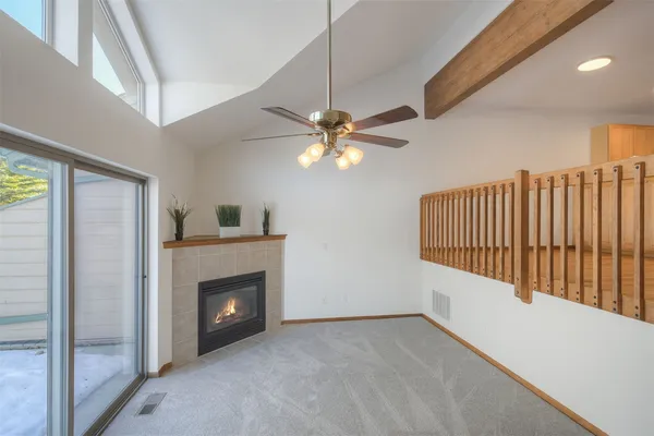 a view of a livingroom with a ceiling fan and window