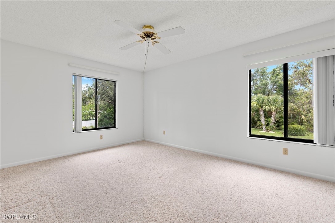 9970 Sailview Court, Unit 9 Fort Myers, FL 33905 - Photo 13 of 20 an empty room with windows