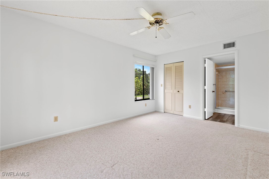 9970 Sailview Court, Unit 9 Fort Myers, FL 33905 - Photo 14 of 20 an empty room with a empty space and a ceiling fan