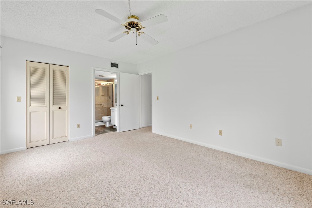9970 Sailview Court, Unit 9 Fort Myers, FL 33905 - Photo 16 of 20 an empty room with a ceiling fan and a window