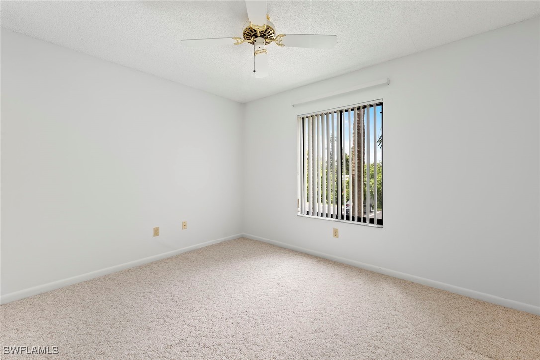9970 Sailview Court, Unit 9 Fort Myers, FL 33905 - Photo 17 of 20 an empty room with a window and a ceiling fan