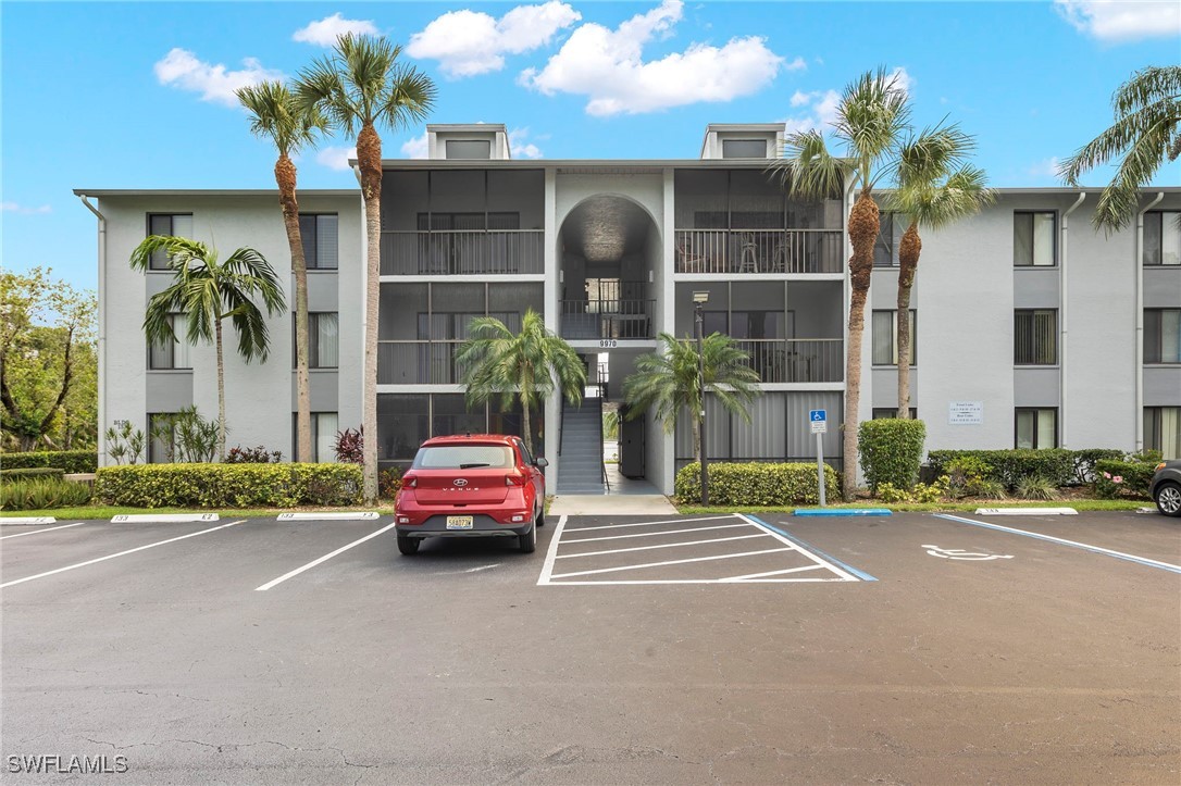 9970 Sailview Court, Unit 9 Fort Myers, FL 33905 - Photo 20 of 20 a front view of a house with a garden and a garage