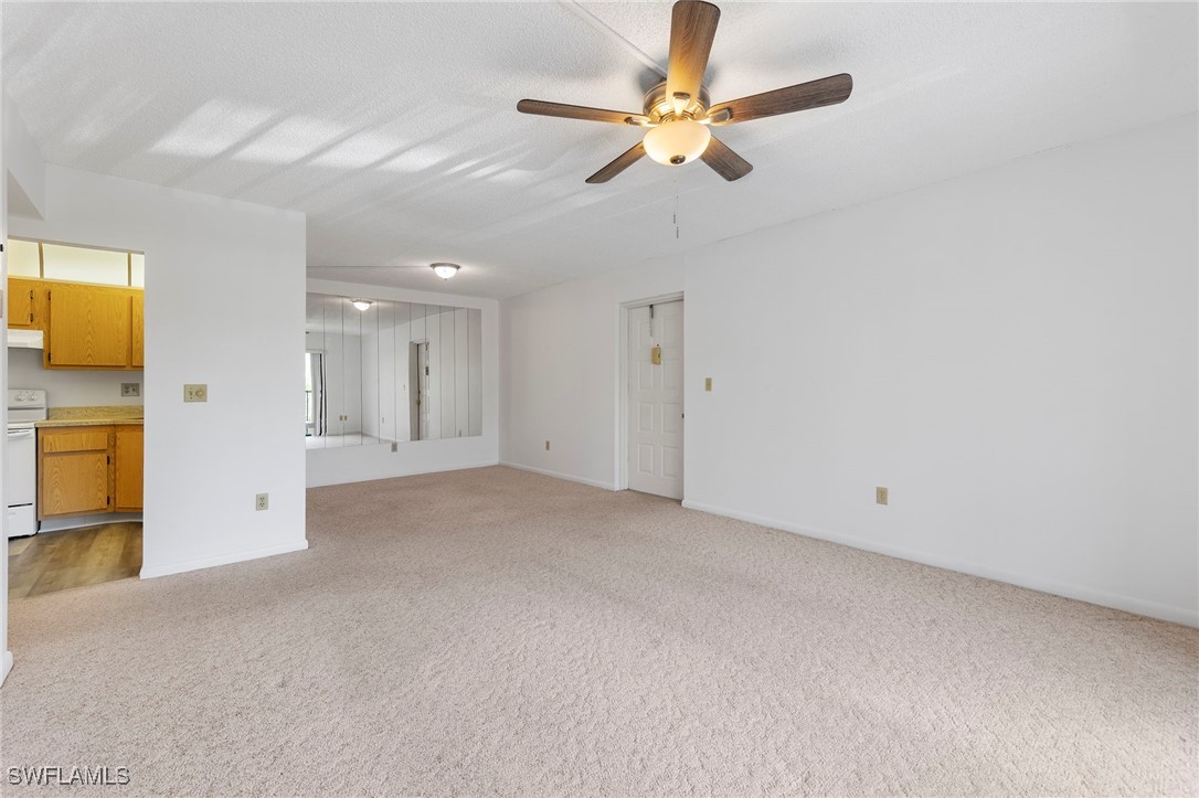 9970 Sailview Court, Unit 9 Fort Myers, FL 33905 - Photo 4 of 20 an empty room with a empty space and a ceiling fan