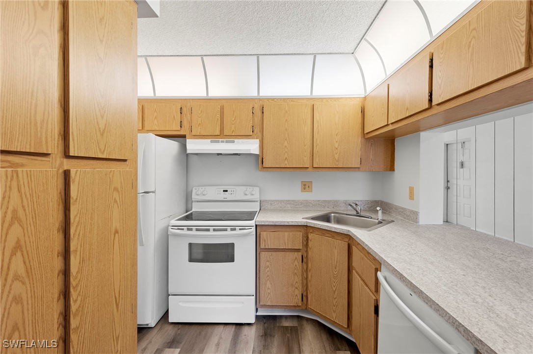 9970 Sailview Court, Unit 9 Fort Myers, FL 33905 - Photo 6 of 20 a kitchen with a sink a stove and cabinets