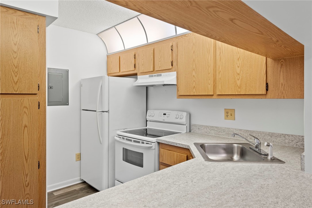 9970 Sailview Court, Unit 9 Fort Myers, FL 33905 - Photo 7 of 20 a kitchen with stainless steel appliances a refrigerator sink and cabinets