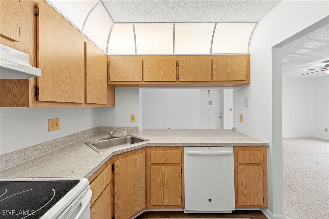 9970 Sailview Court, Unit 9 Fort Myers, FL 33905 - Photo 9 of 20 a kitchen with stainless steel appliances granite countertop a sink a stove and cabinets