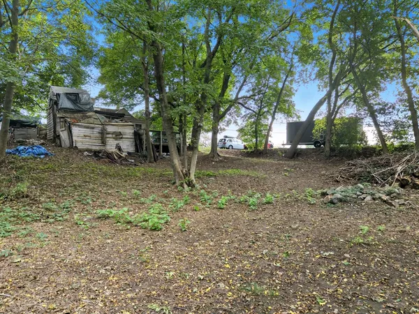 a backyard of a house with table and chairs