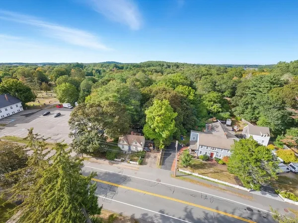 an aerial view of residential house with green space