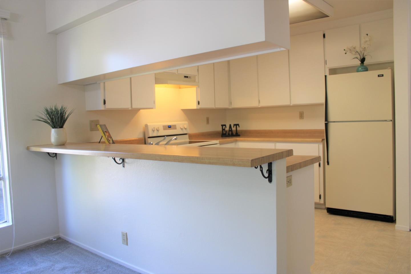 2298 Almaden Road, Unit B San Jose, CA 95125 - Photo 9 of 21 a kitchen with a sink a refrigerator a counter top space and cabinets