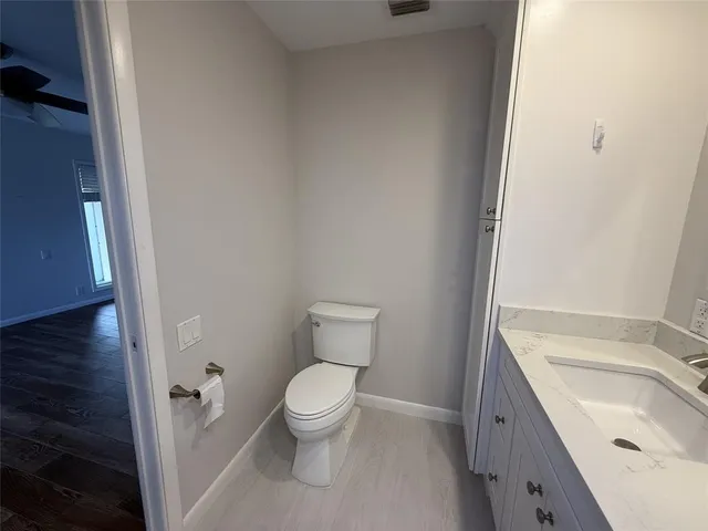 a white toilet sitting next to a bathroom sink