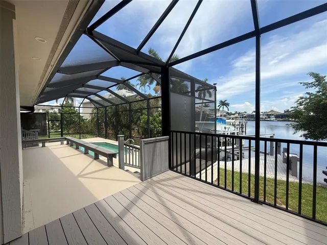 a view of balcony with wooden floor and outdoor seating