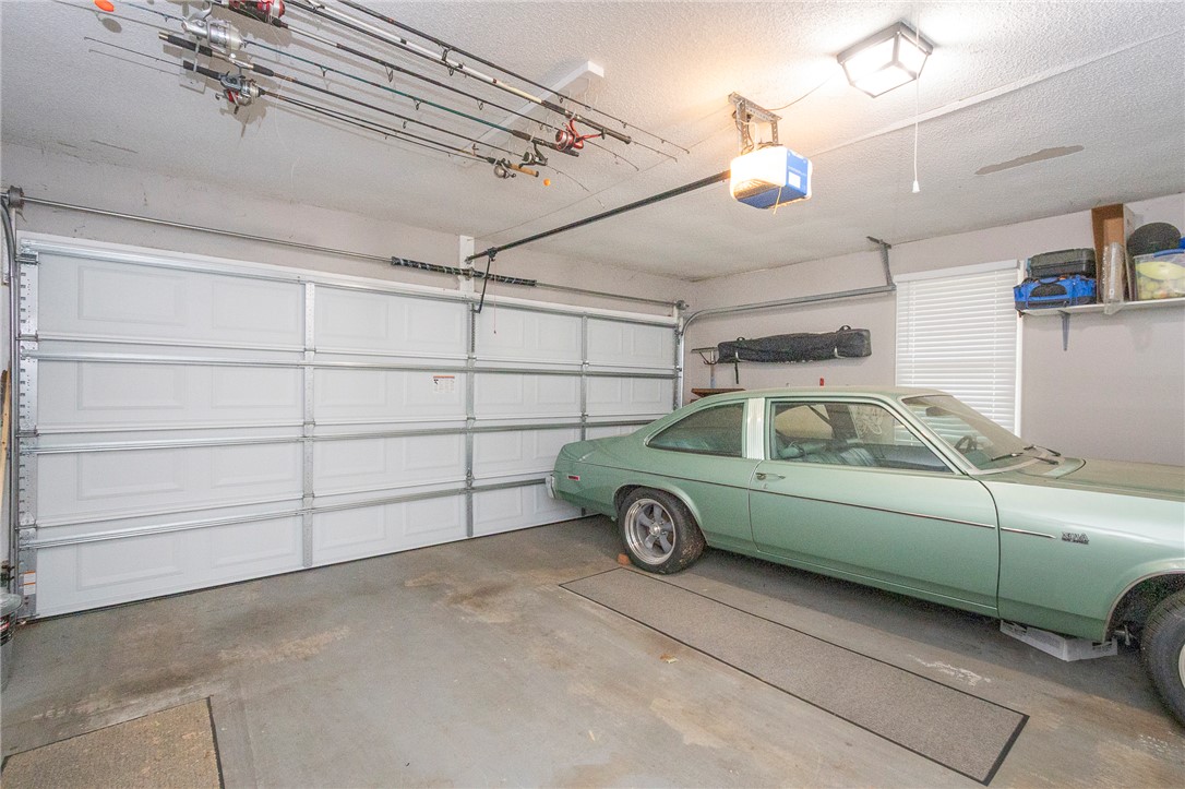 203 Oak Hollow Pendleton, SC 29670 - Photo 19 of 50 A spacious garage features a white panel door and a dedicated area for storage and hobbies.