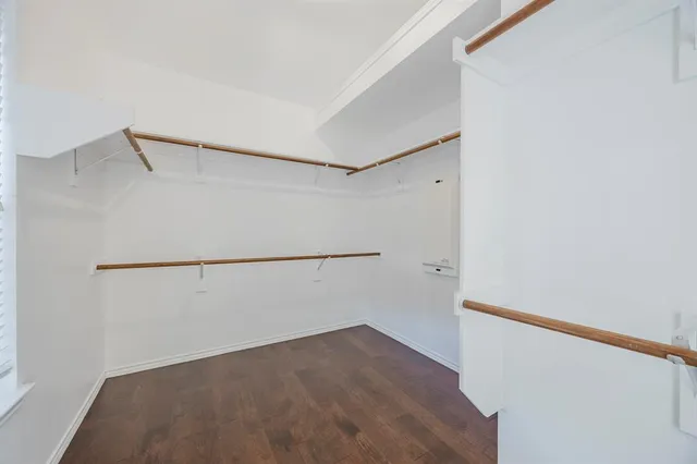 a view of walk in closet with empty racks