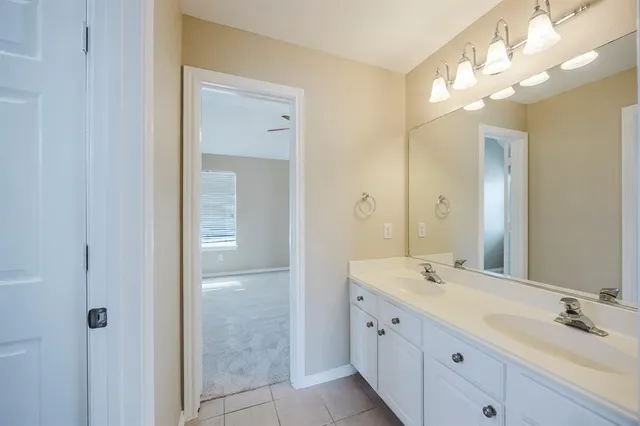 a bathroom with a double vanity sink and a mirror