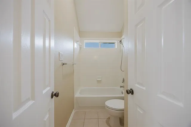 a bathroom with a granite countertop toilet a sink and bathtub
