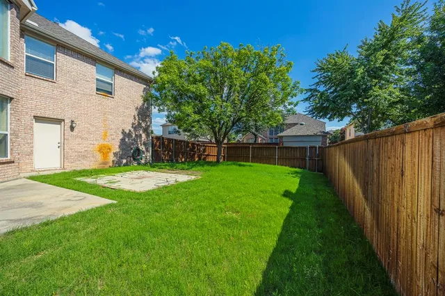 a view of yard with grass and a trees