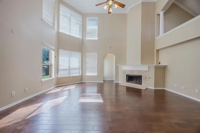a view of an empty room with exposed radiator and fireplace