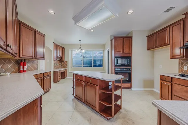 a kitchen with stainless steel appliances granite countertop a stove and a refrigerator