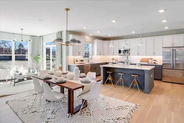 a large kitchen with a table and chairs