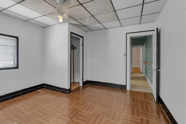a view of an empty room with wooden floor