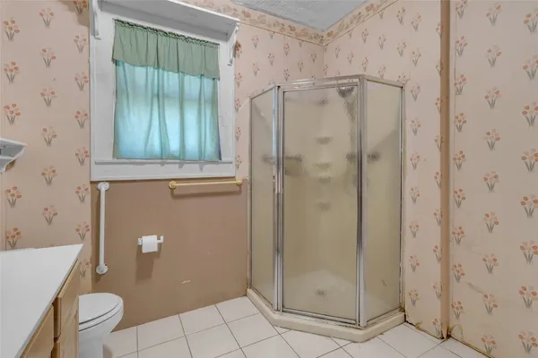 a bathroom with a shower and a toilet