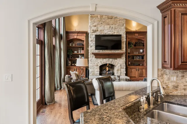 a view of a house with a yard and large tree