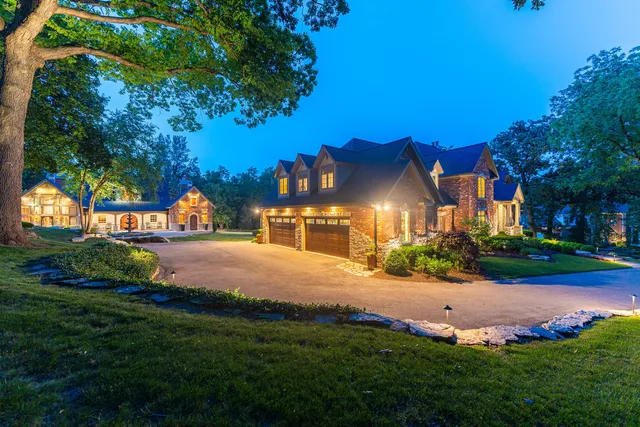 a kitchen with stainless steel appliances granite countertop a stove refrigerator and couches with wooden floor
