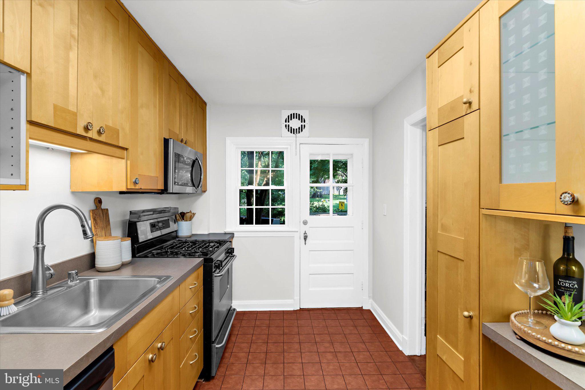 218 Blenheim Road Baltimore, MD 21212 - Photo 14 of 31 a kitchen with granite countertop a sink and a stove top oven