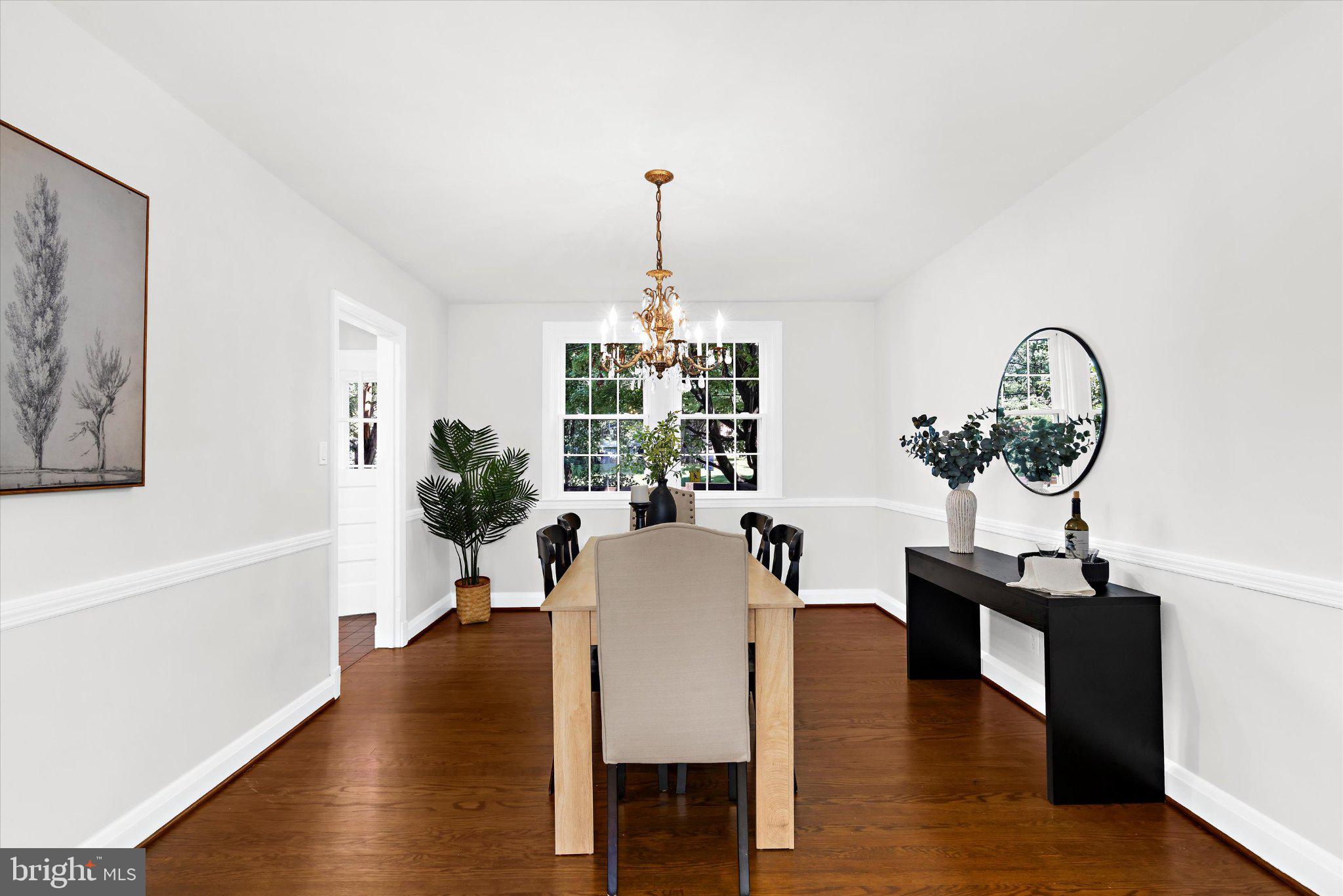 218 Blenheim Road Baltimore, MD 21212 - Photo 7 of 31 a dining room with furniture potted plants and wooden floor
