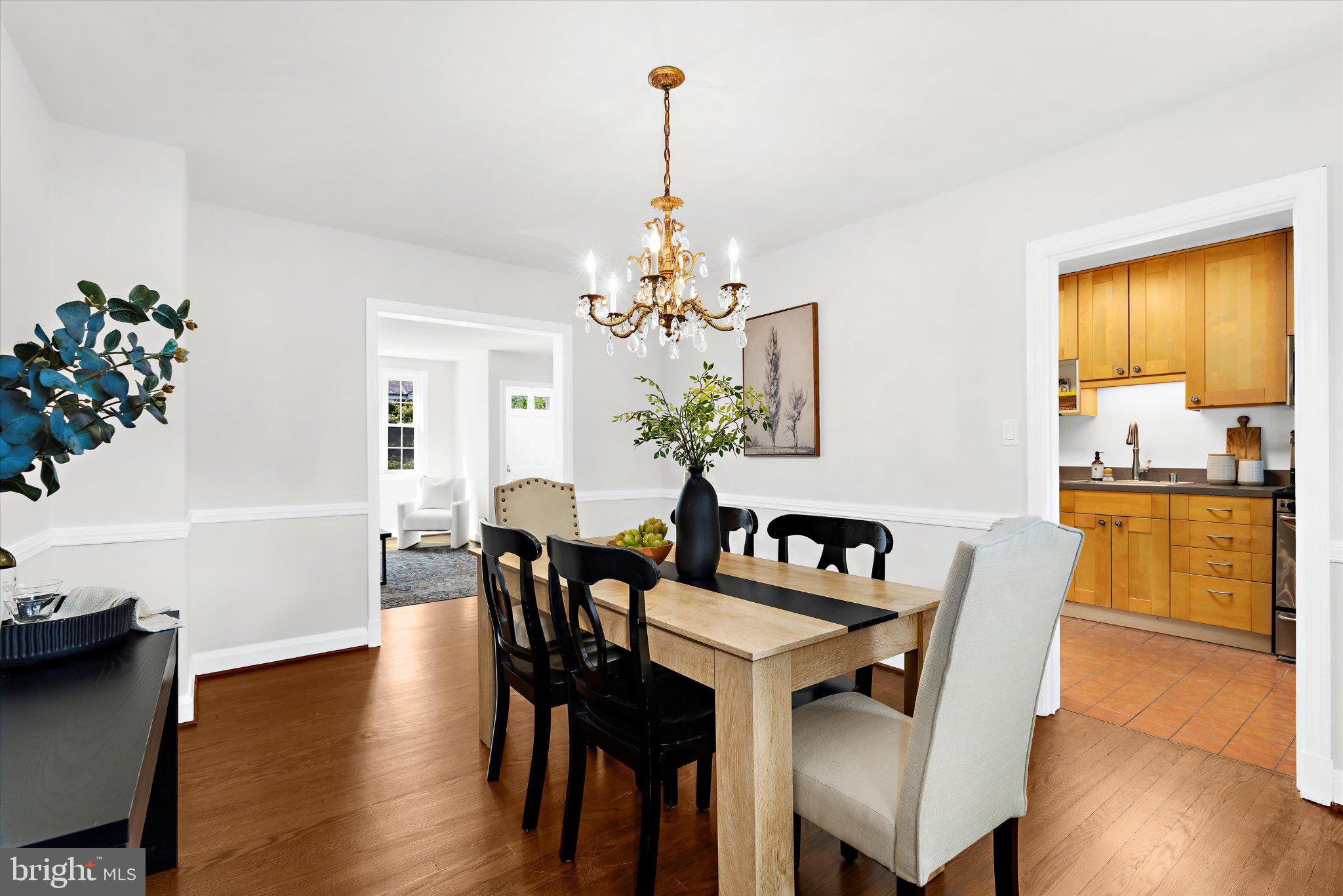 218 Blenheim Road Baltimore, MD 21212 - Photo 8 of 31 a dining room with furniture potted plants and wooden floor